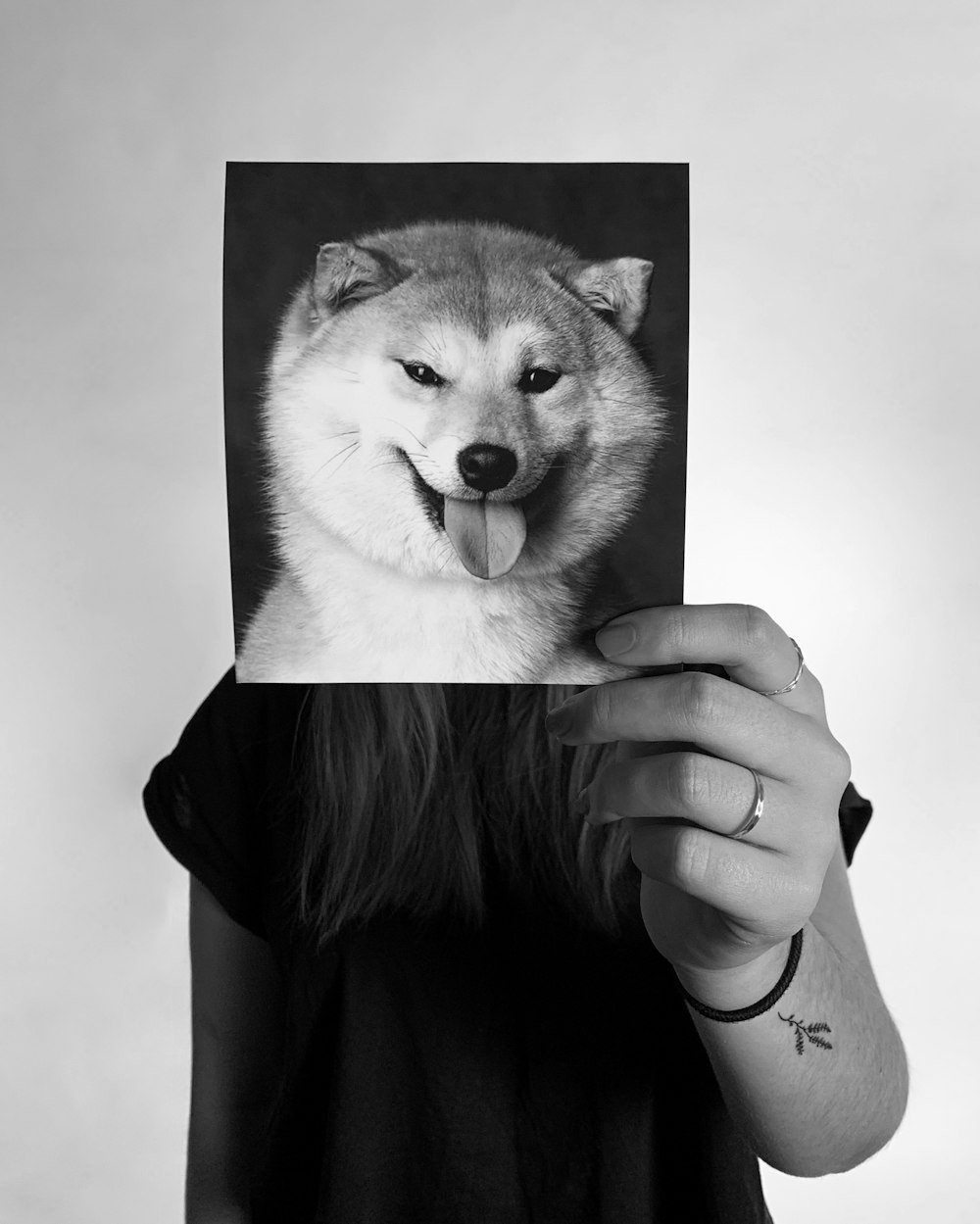 person holding photo of dog