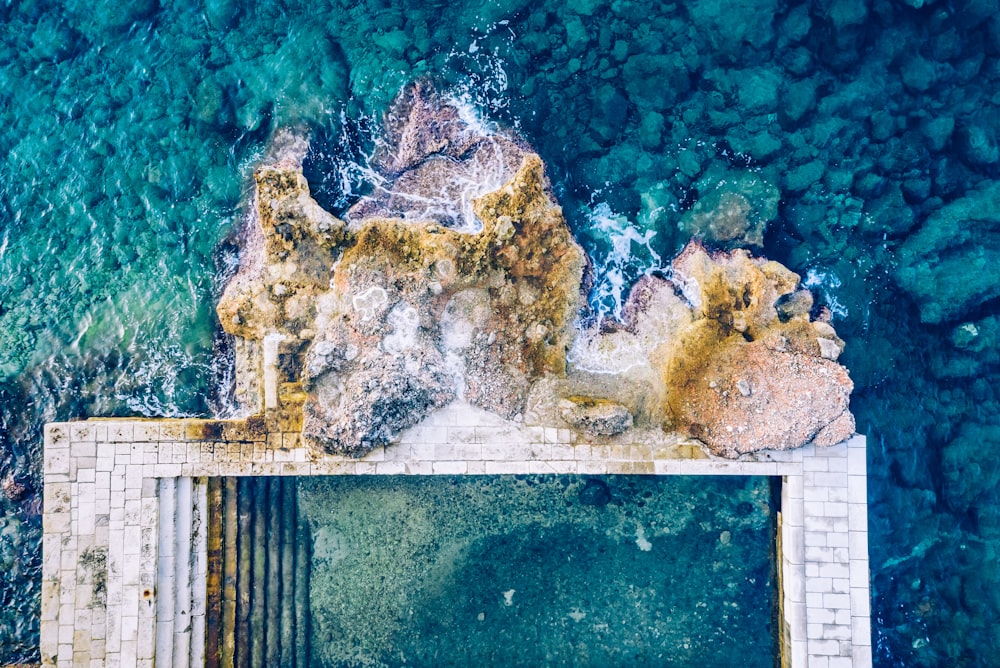 aerial photography of rock formations near body of water during daytime