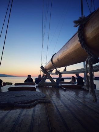 Group of students learning sailing basics on deck