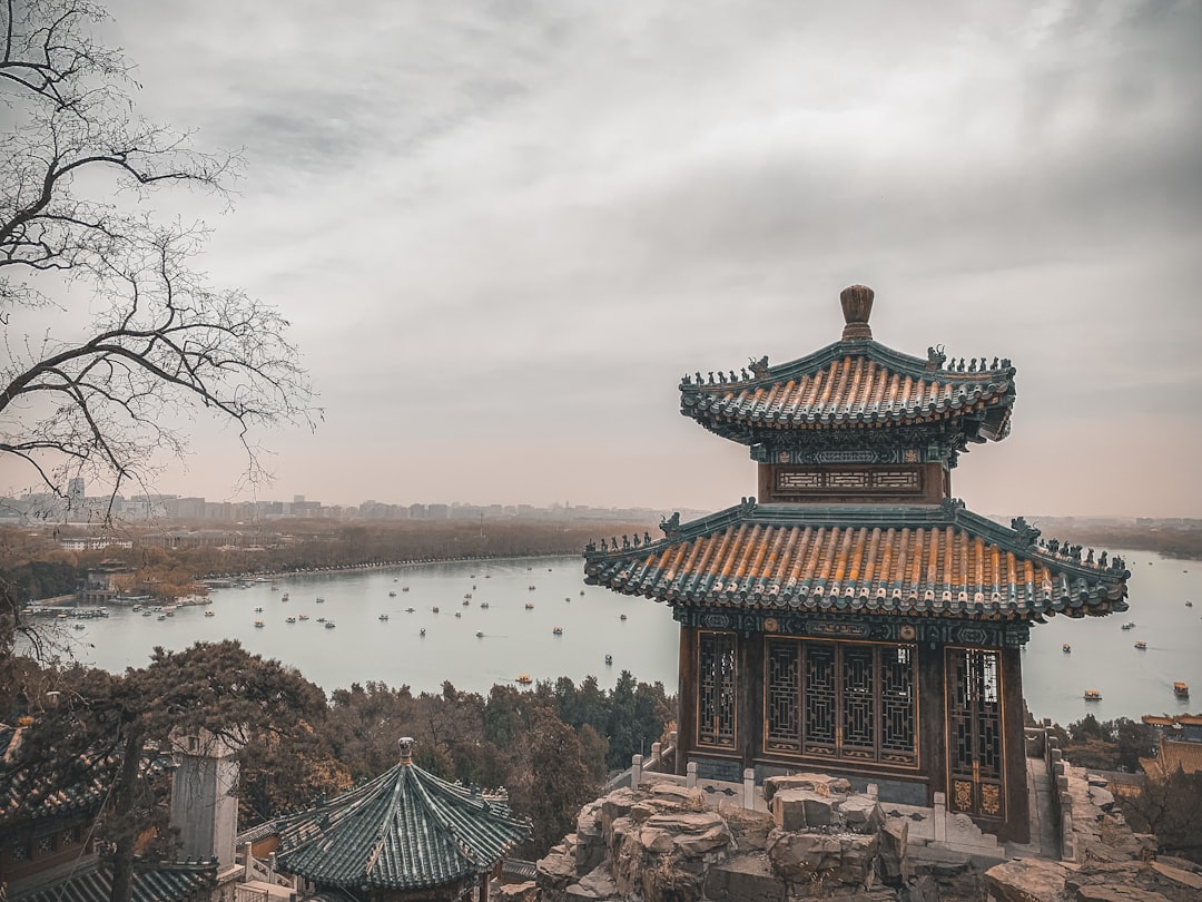 boats on body of water near Summer Palace under white and blue sky,