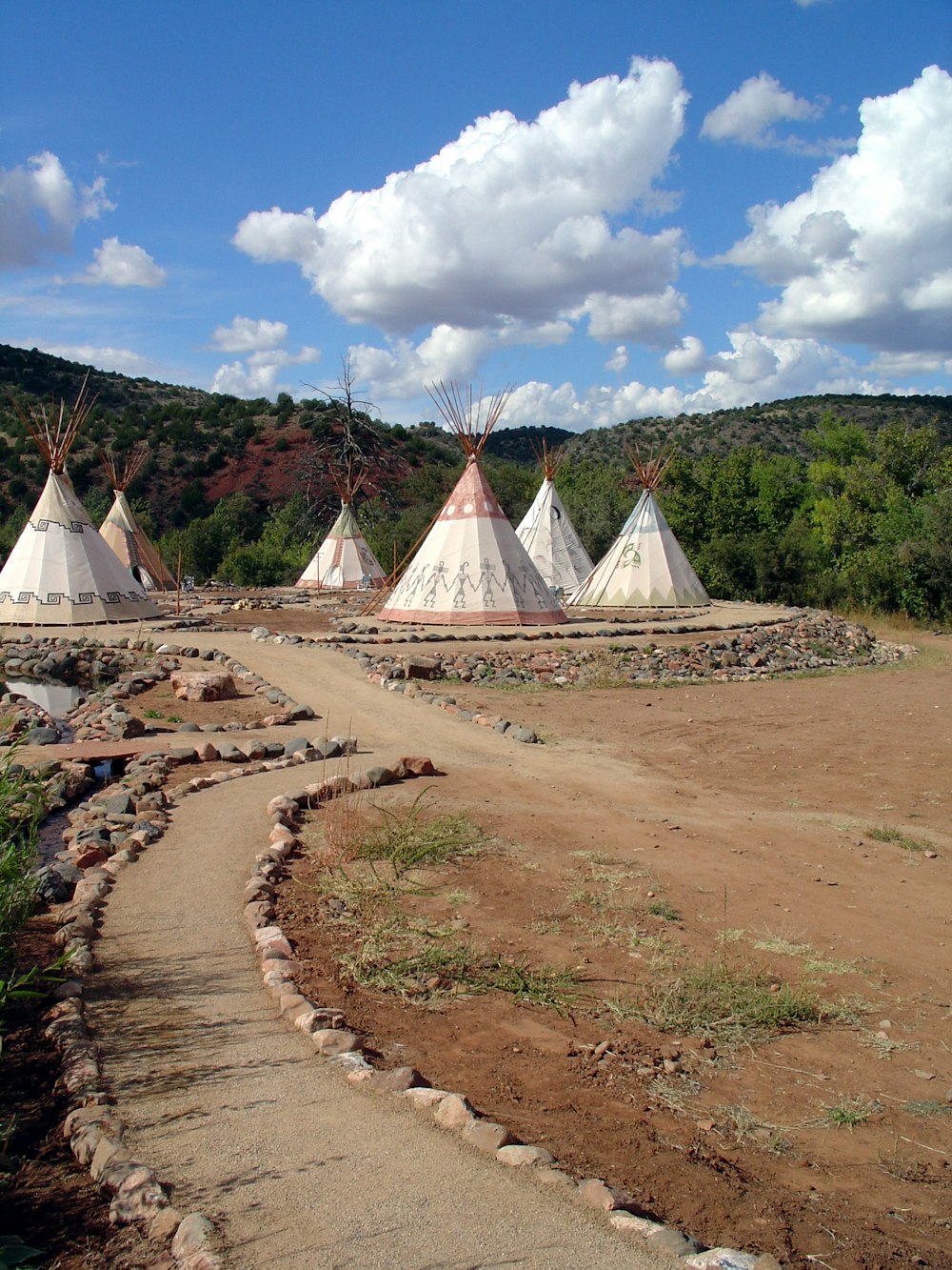 six white teepee tents on ground