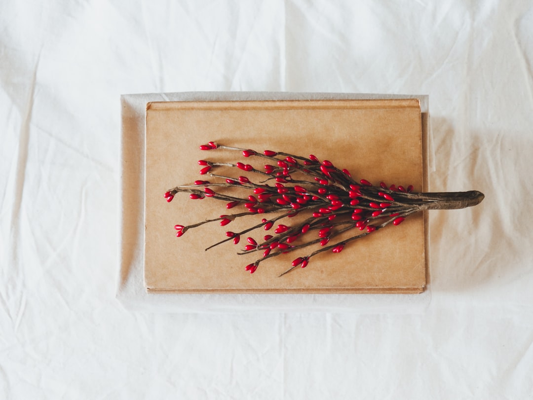 red and brown plant on book