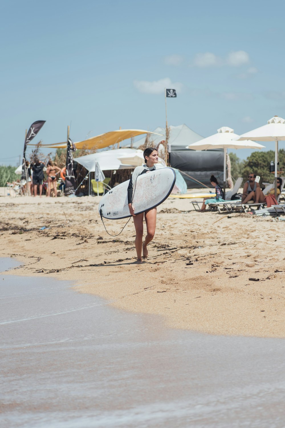 woman holding white surfboard during daytime