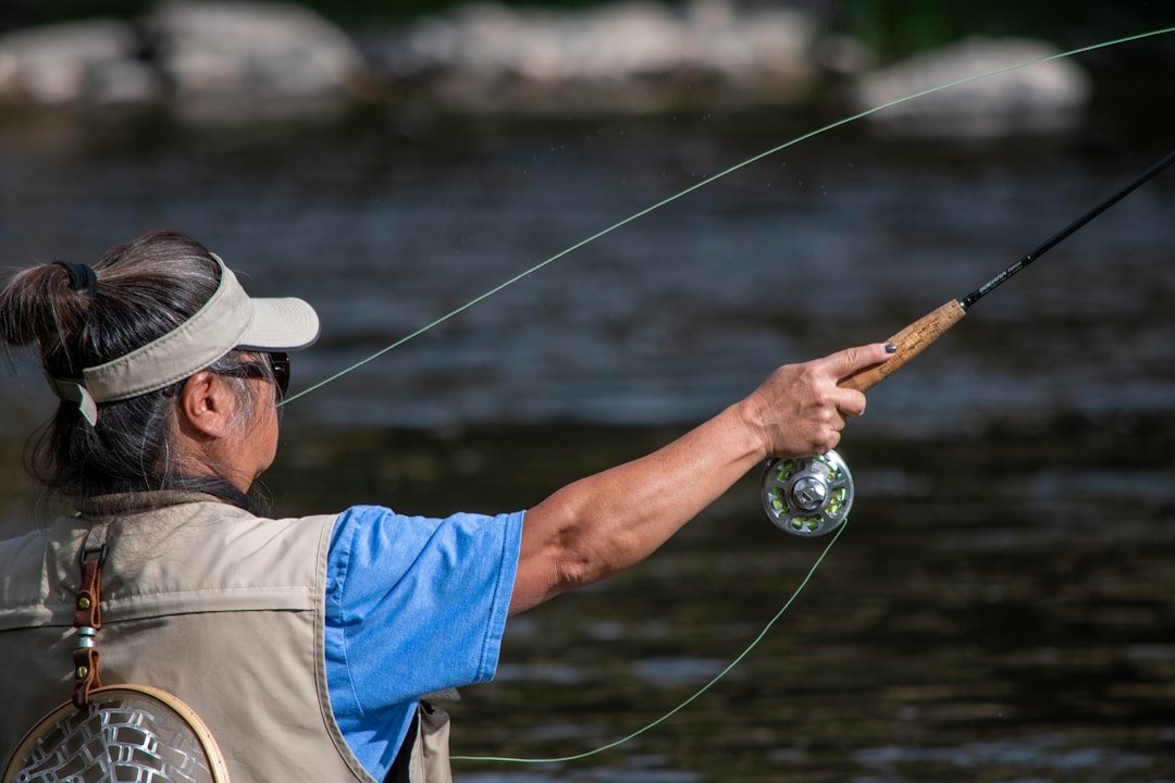 Angler fishing by the river