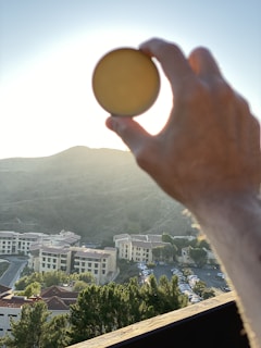A happy customer holding a camera outdoors, showcasing the use of Hri-Filters in natural light.
