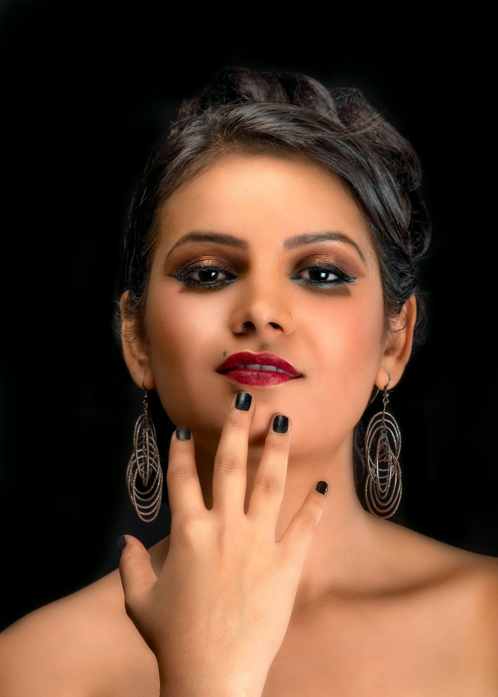 woman wearing red lipstick with right hand on chin