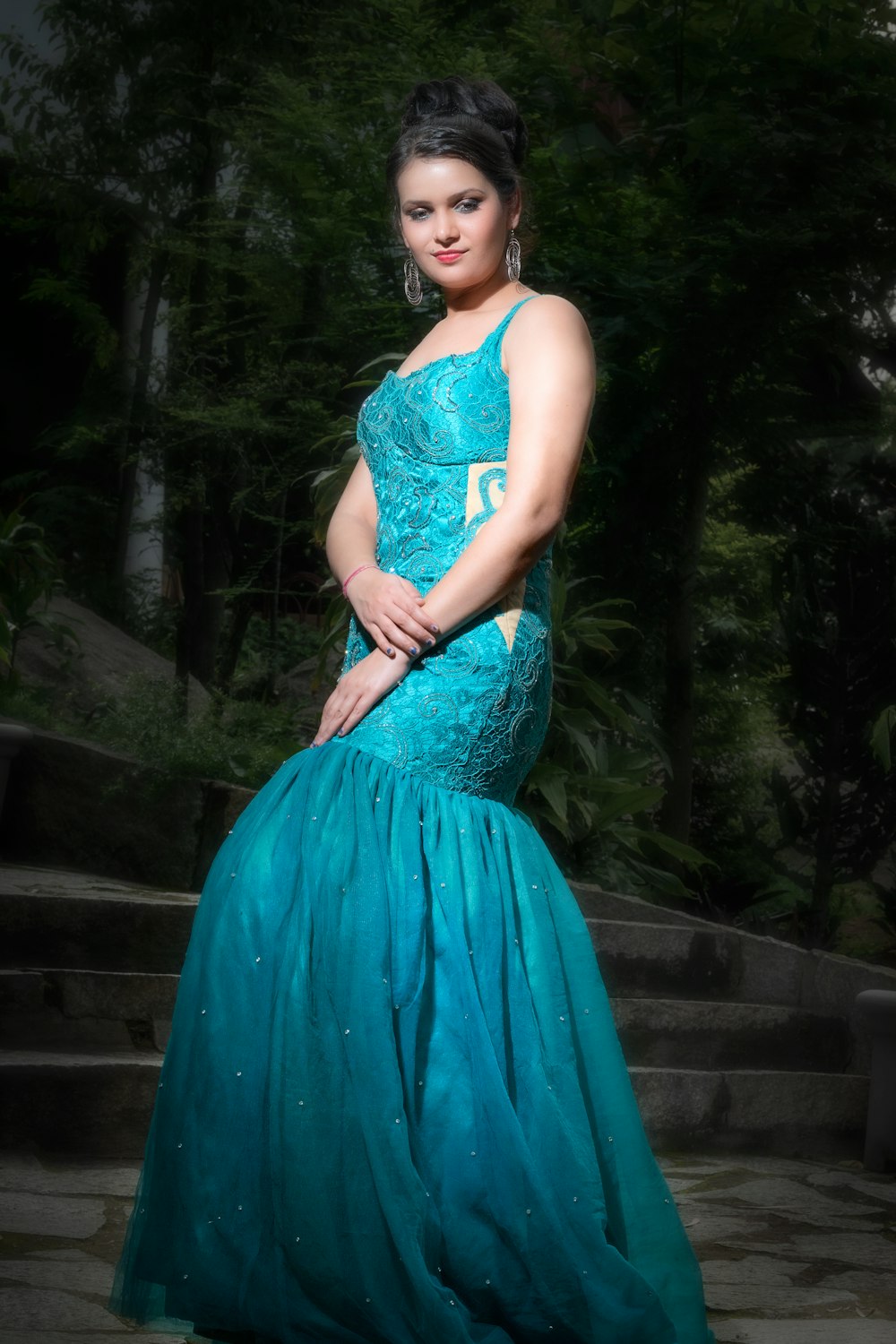 standing woman wearing blue spaghetti strap dress during daytime