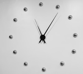 black and silver analog clock displaying 11:06 time