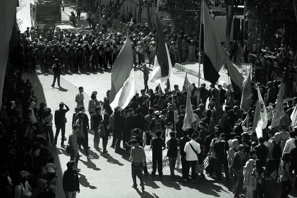 grayscale photography of crowd holding banners