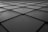 A grid pattern consisting of square tiles with slightly beveled edges, creating a sense of depth and perspective. The surface appears smooth with some small scratches or marks visible.
