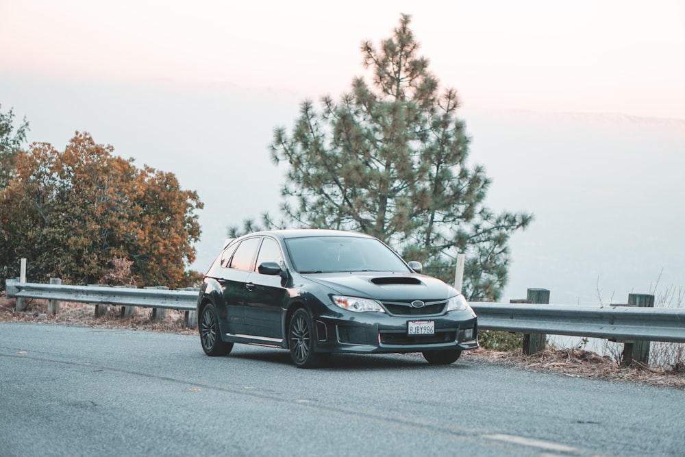 black hatchback on road