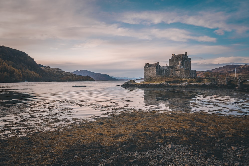 brown stone building near the body of water