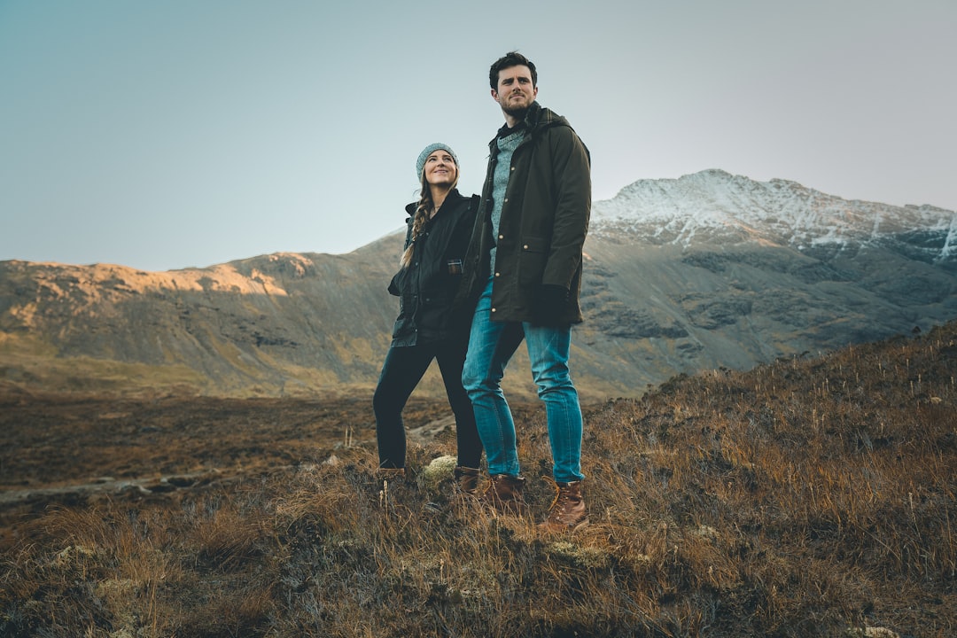 man and woman standing on plant field