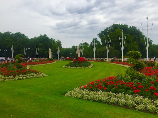 A well-maintained park with walking paths and colorful flower beds.