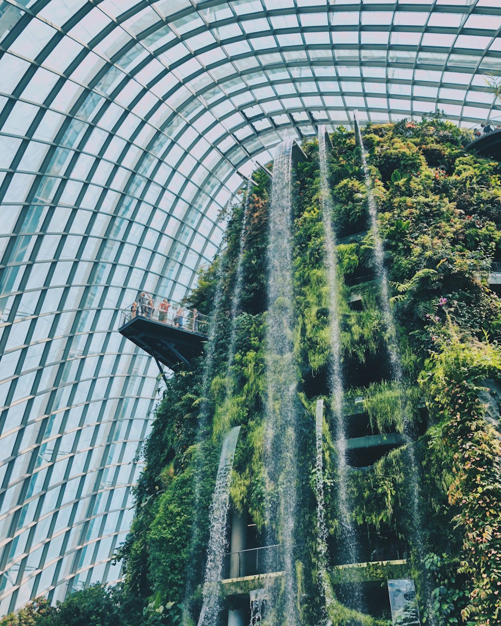 the inside of a building with a waterfall inside of it