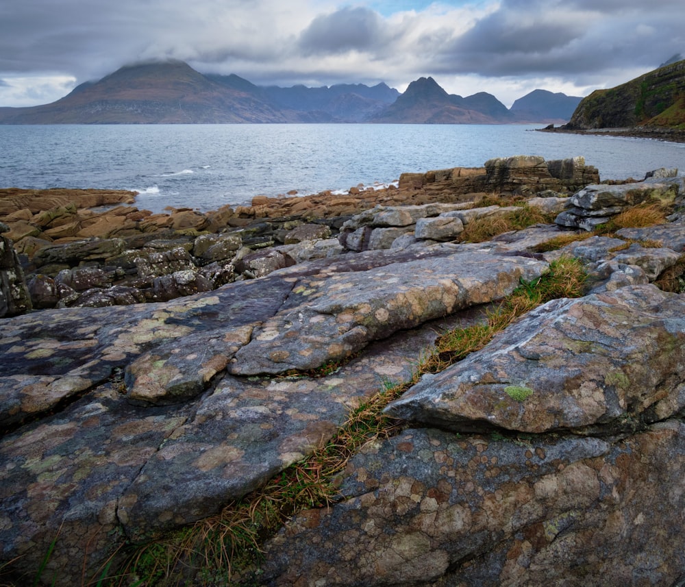 body of water and brown rock formation