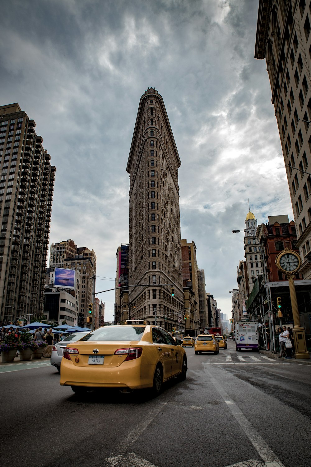 vehicles crossing beside flat iron building