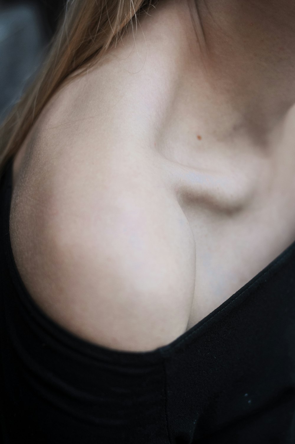 a close up of a woman's breast with a cell phone in her hand