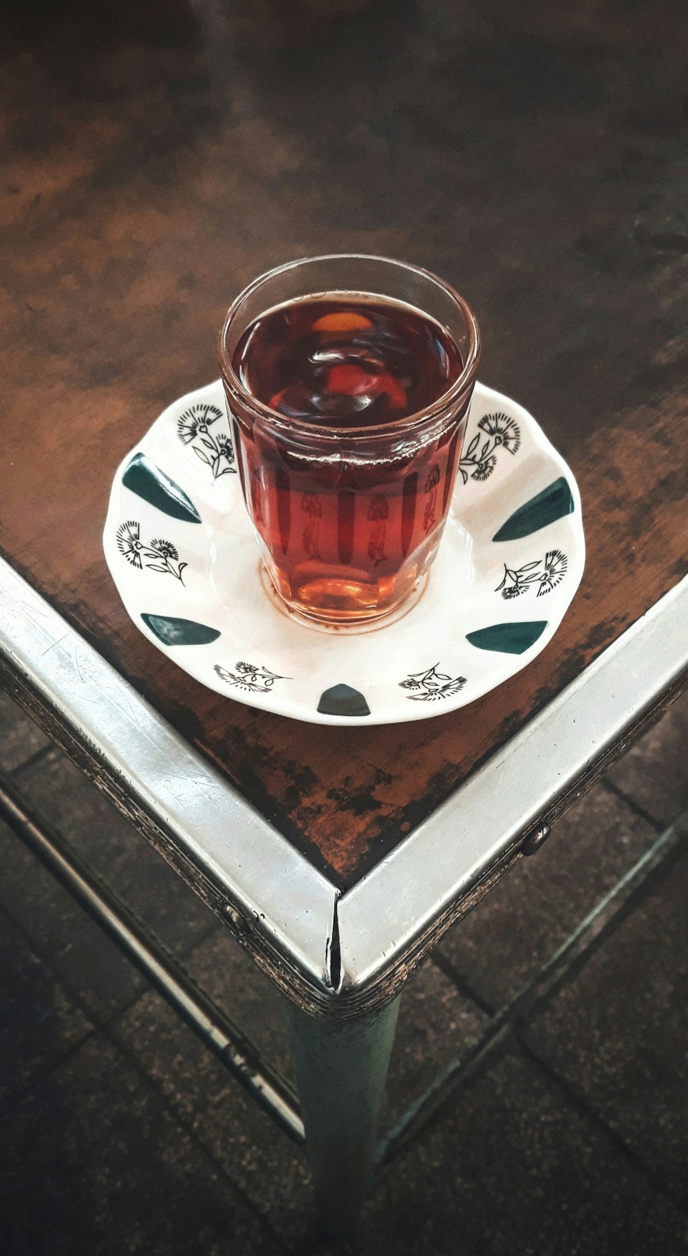 clear glass mug on white saucer filled with liquid