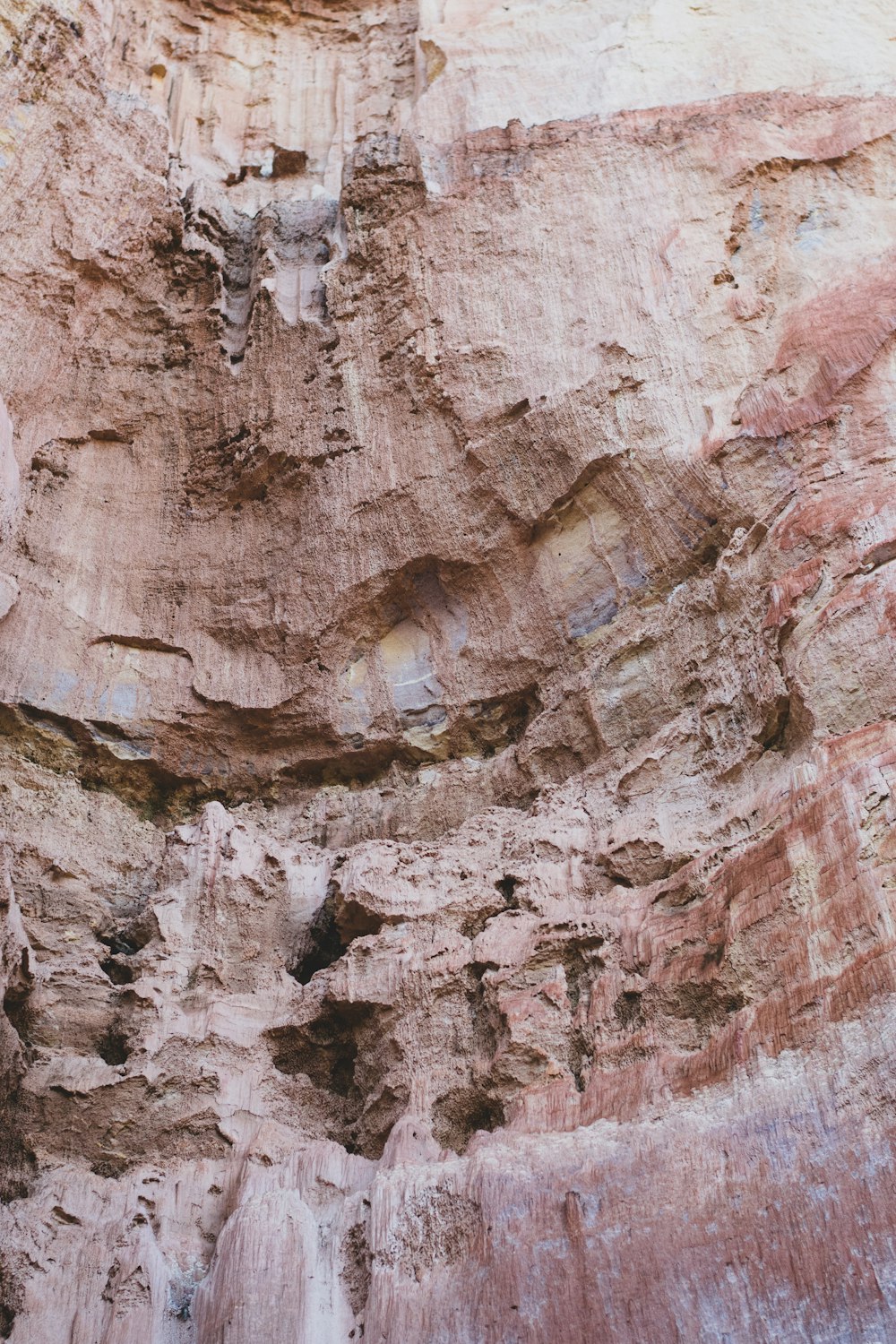 a man standing in front of a large rock formation