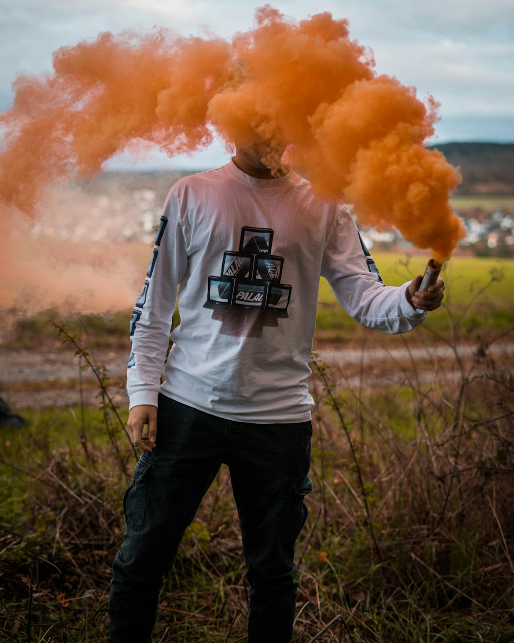 man standing and smoking during daytime