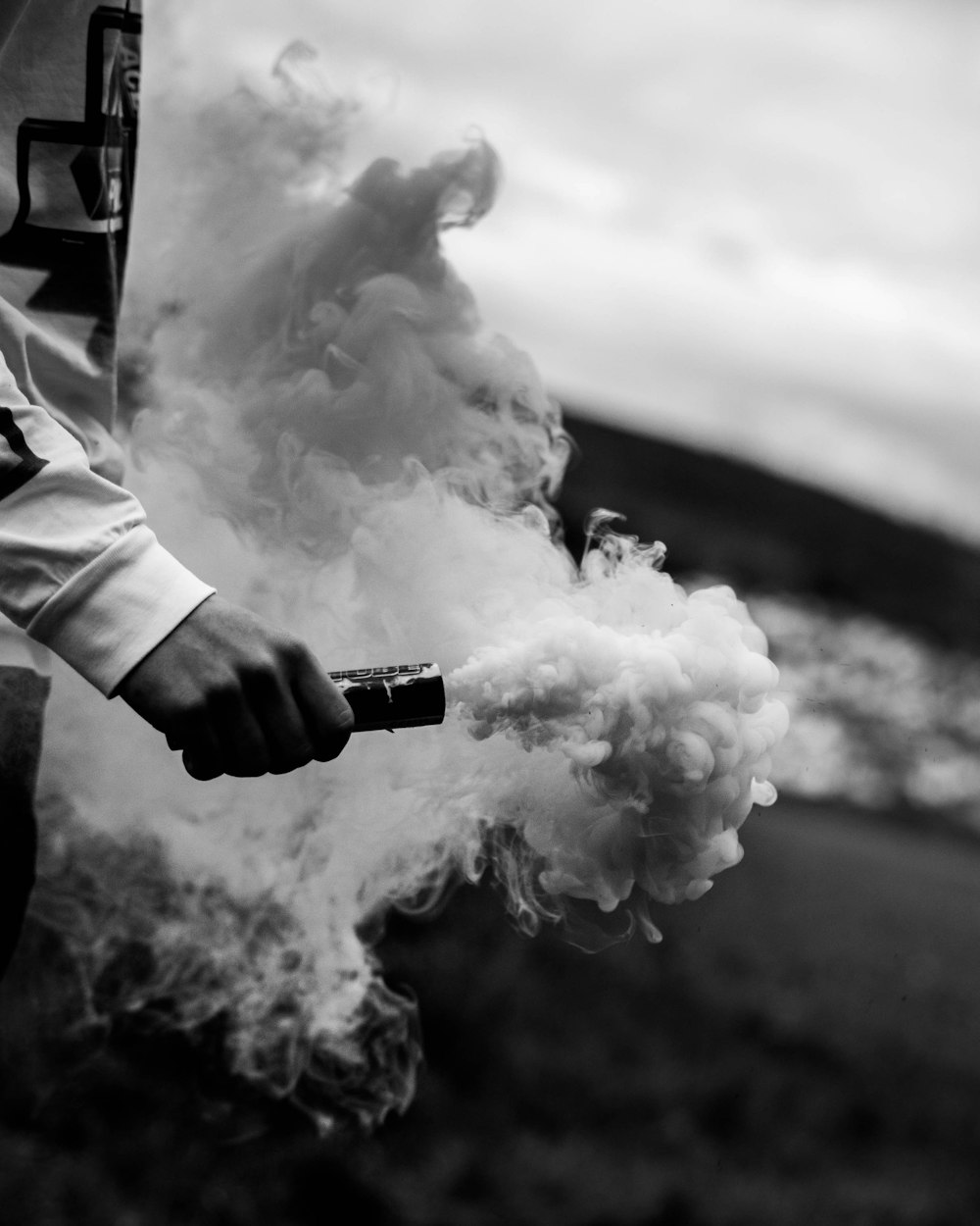 man holding smoking rod