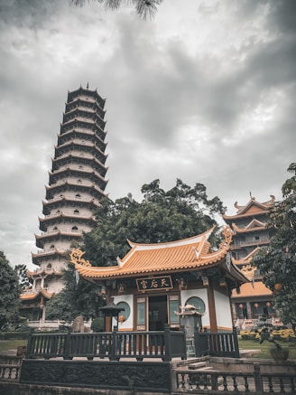 orange and white temple under white and gray sky