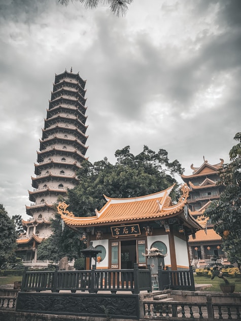 orange and white temple under white and gray sky
