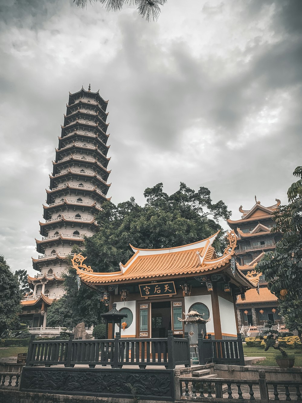 orange and white temple under white and gray sky