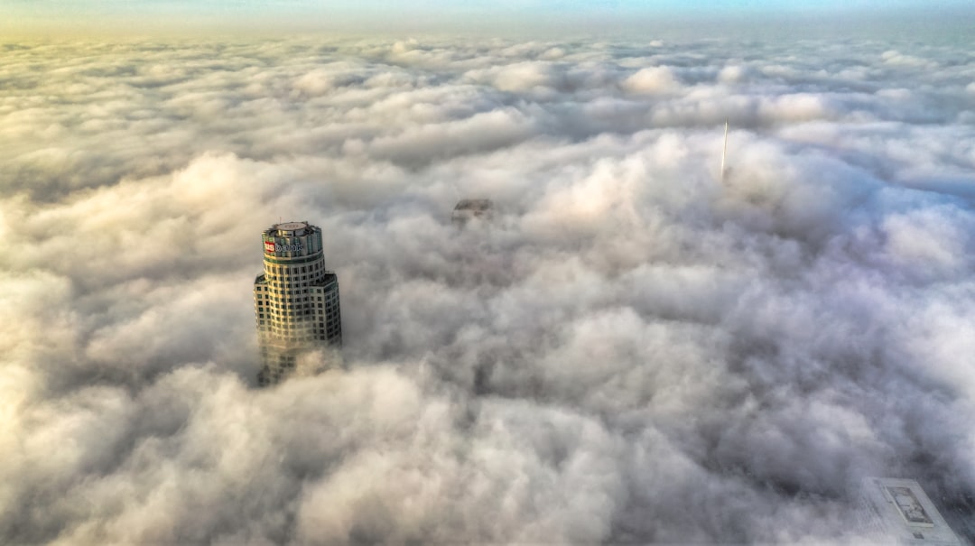 high-rise building beside clouds