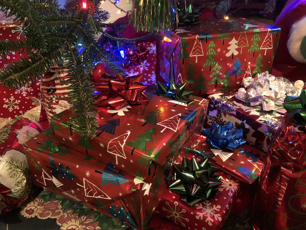 assorted-colored gift boxes near Christmas tree