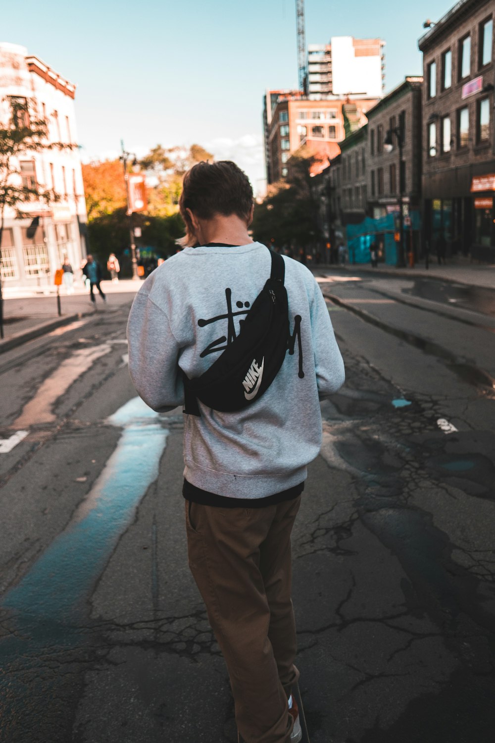 man walking on road between daytime