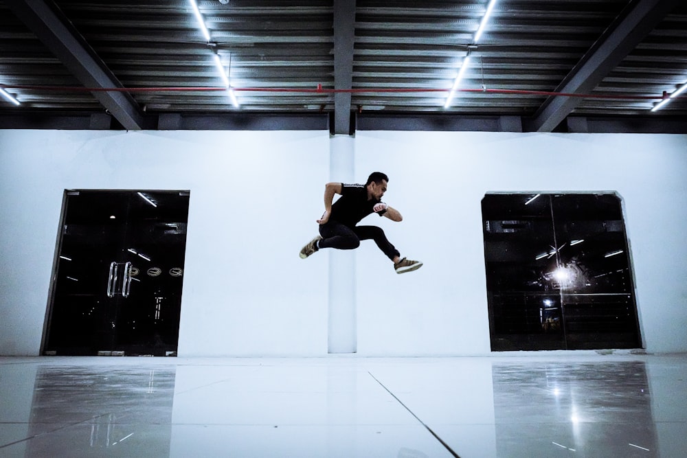 man jumping inside building