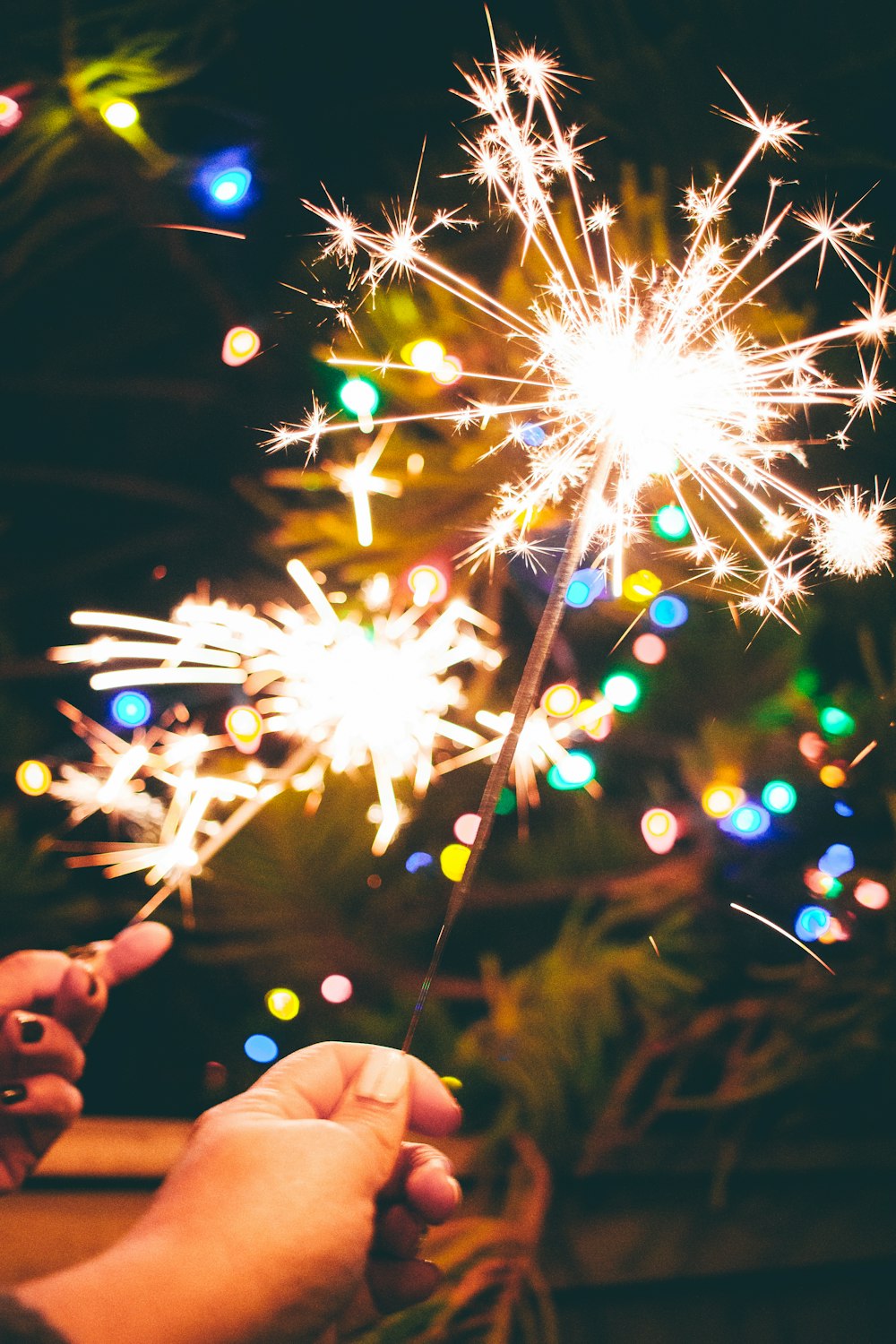 a person is holding a sparkler in their hand