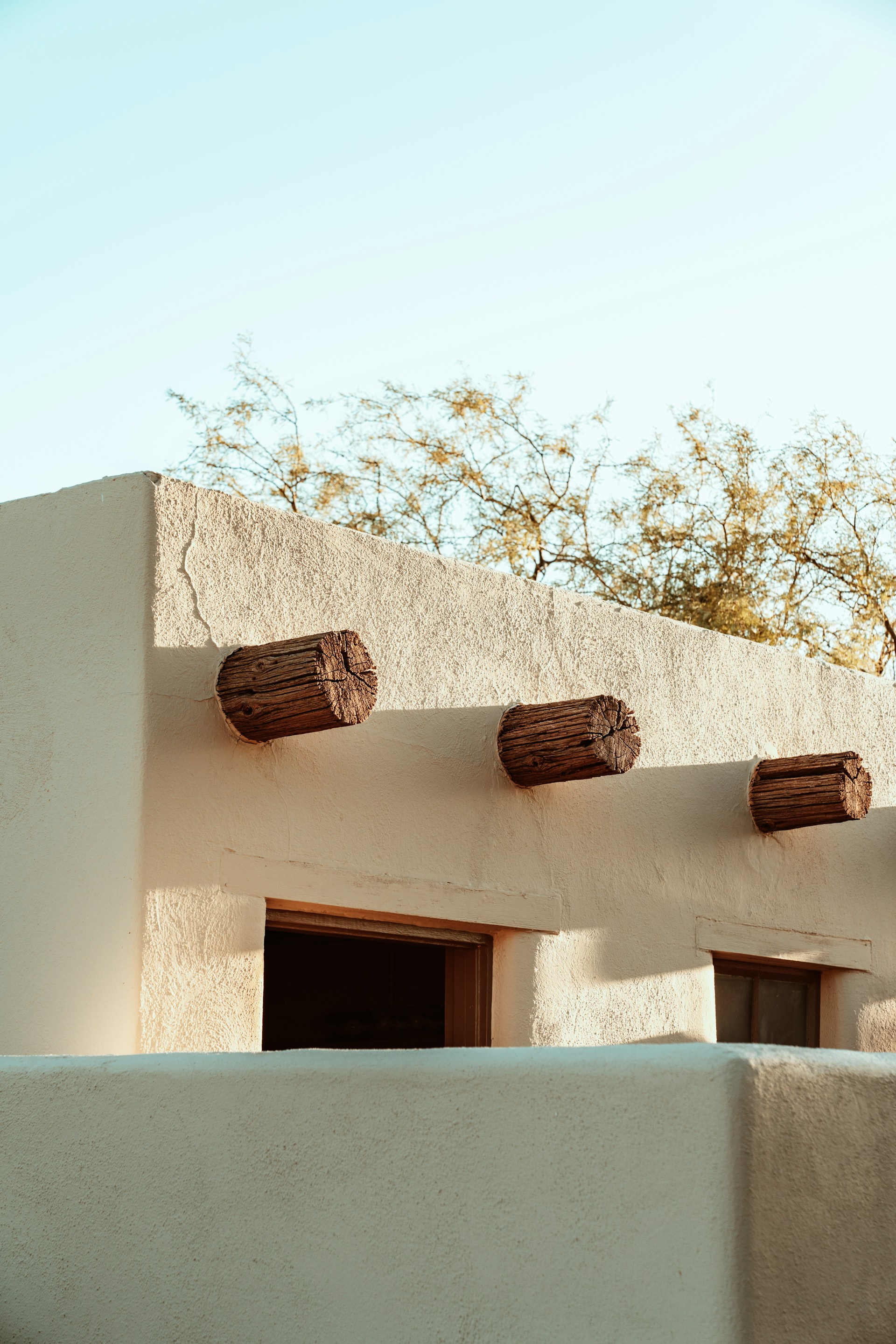 the roof of a building with three wooden barrels on top of it