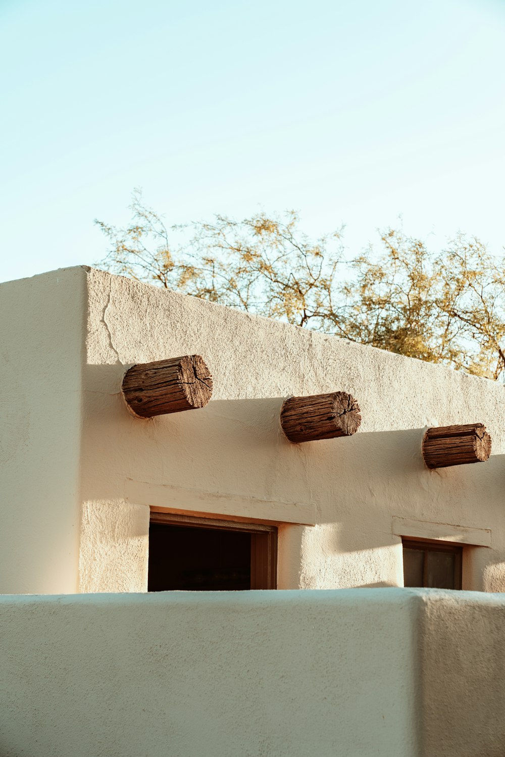 the roof of a building with three wooden barrels on top of it