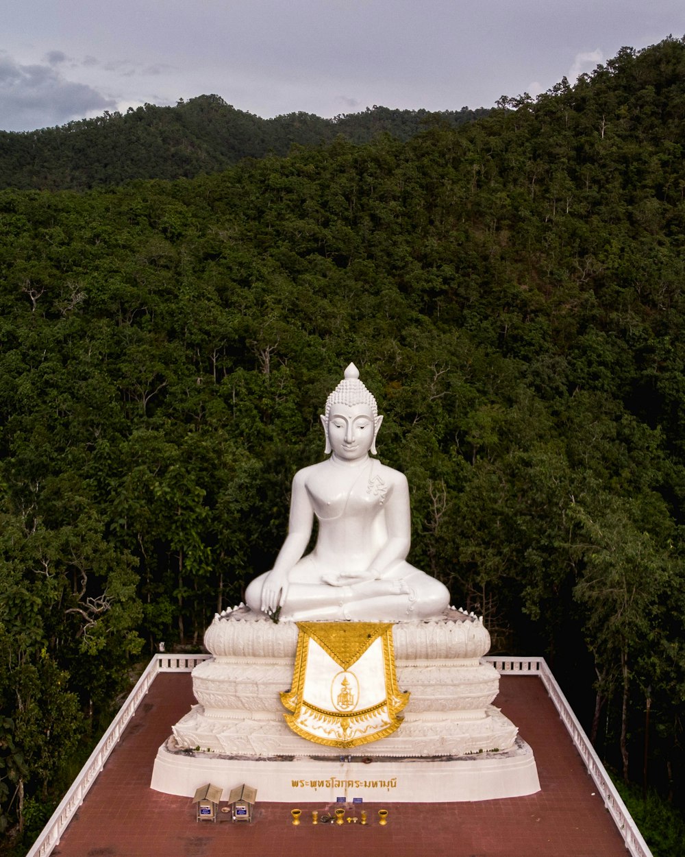 white Buddha statue surrounded with green trees