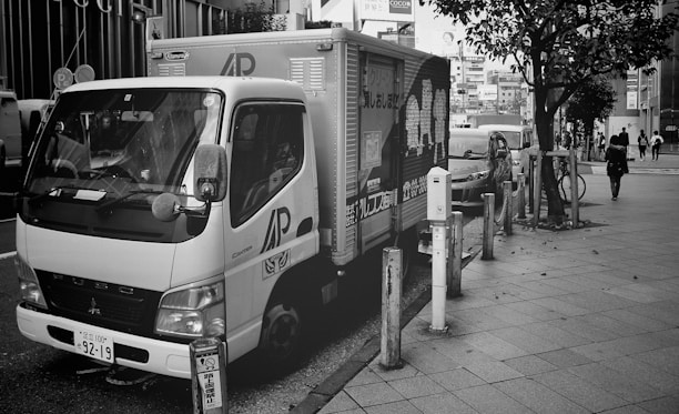 A truck delivering goods on a city street, representing municipal freight transport.