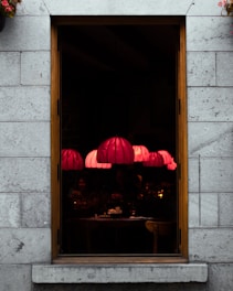 Cozy interior of Le Volpi restaurant with warm lantern beige lighting at sunset.