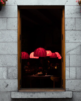 Warm, inviting interior shot of txori's tapas bar with softly glowing pendant lights and patrons enjoying pintxos and wine.