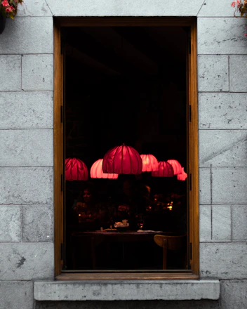 Warm, inviting interior shot of txori's tapas bar with softly glowing pendant lights and patrons enjoying pintxos and wine.