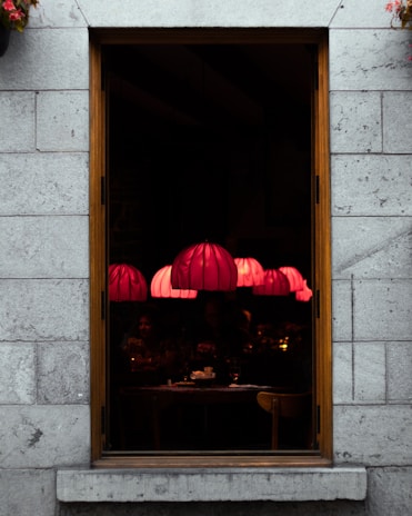 Cozy interior of Le Volpi restaurant with warm lantern beige lighting at sunset.