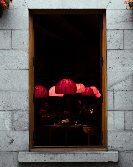 Dimly lit interior of noirflamme with sizzling steaks on the grill and a small stage for live musicians.