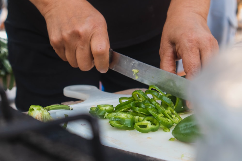 person slicing vegetables