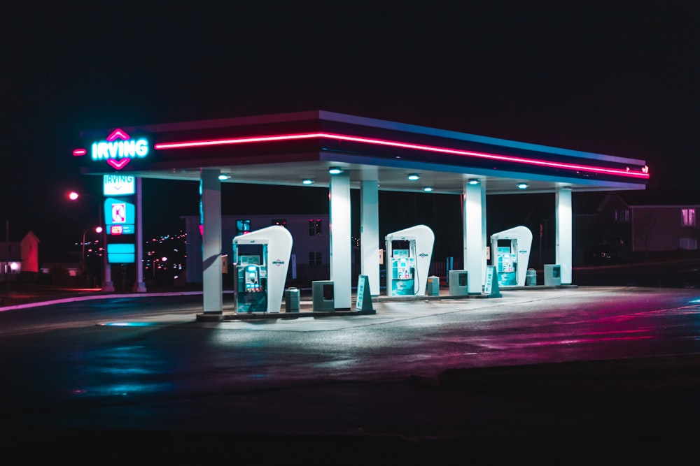 white and blue gas station at night