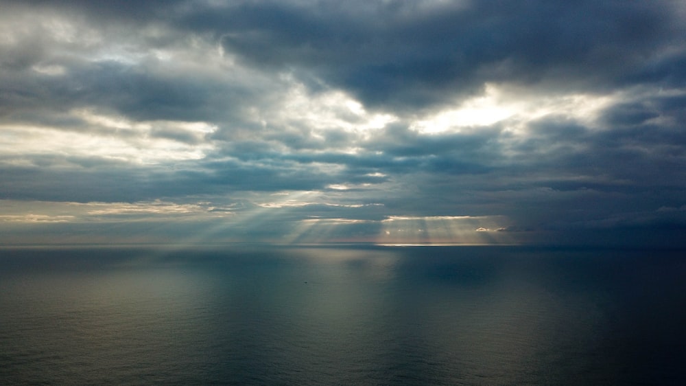 blue ocean under blue and white sky