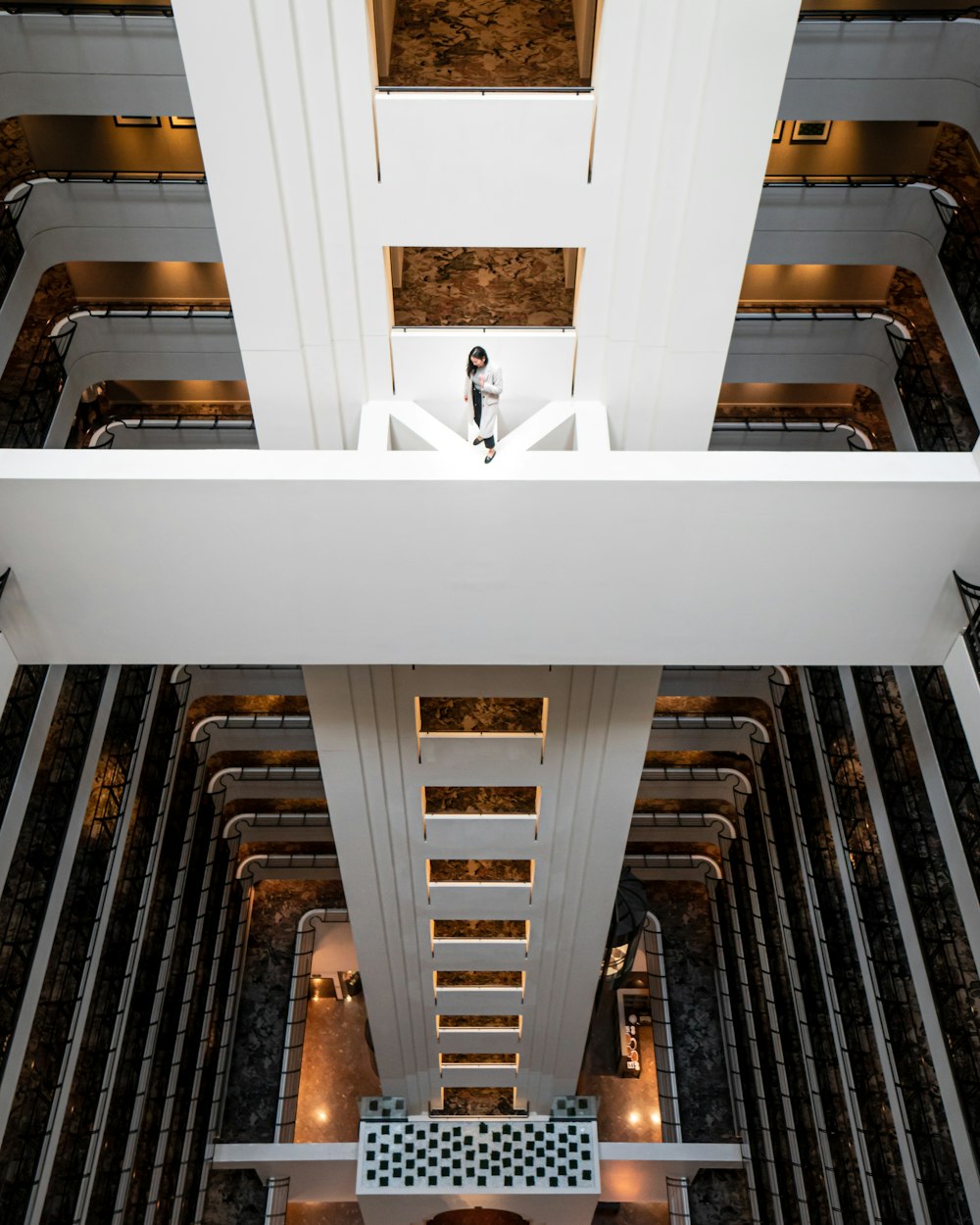 a person standing on a balcony in a building