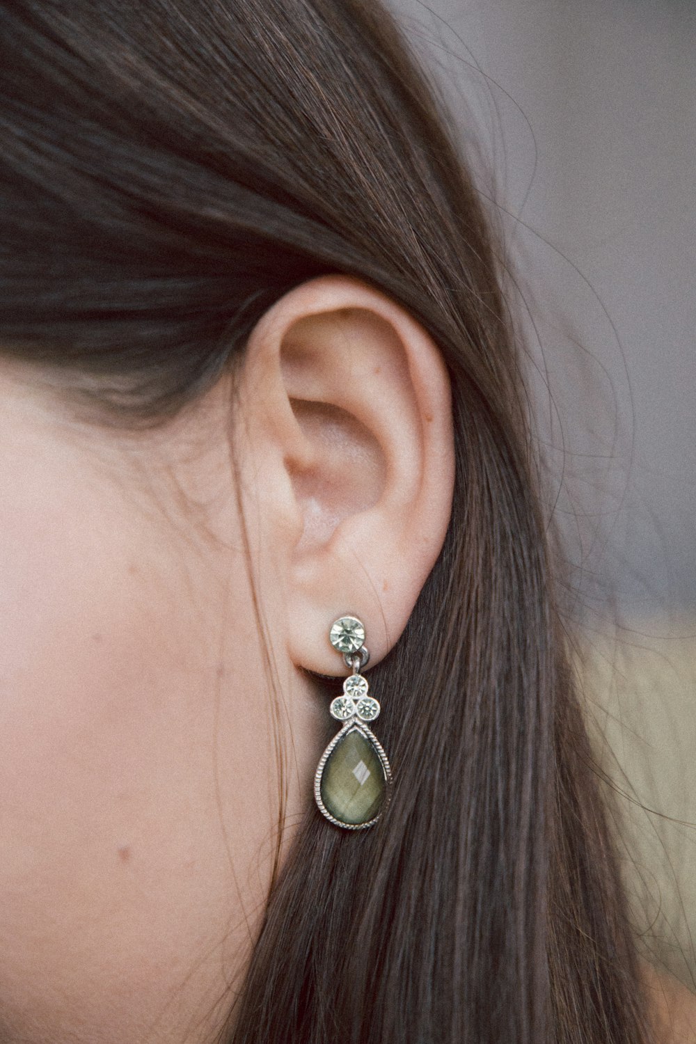 woman silver-colored earring