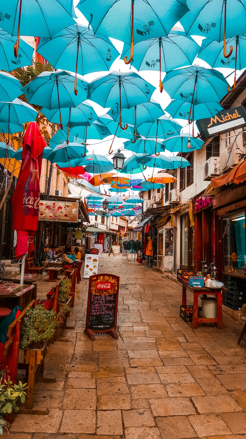 view photography of blue umbrellas in stores