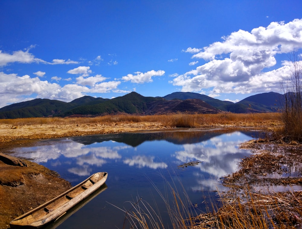 boat docked beside land during day